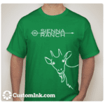 A man wearing a Green Goat T-Shirt that says sienna ranch.