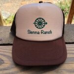 A trucker hat with the word Sienna Ranch on it.