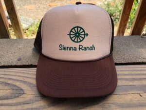 A trucker hat with the word Sienna Ranch on it.